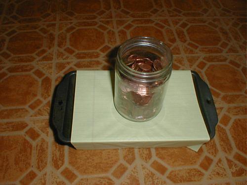 penny jar on paper stretched across loaf pan